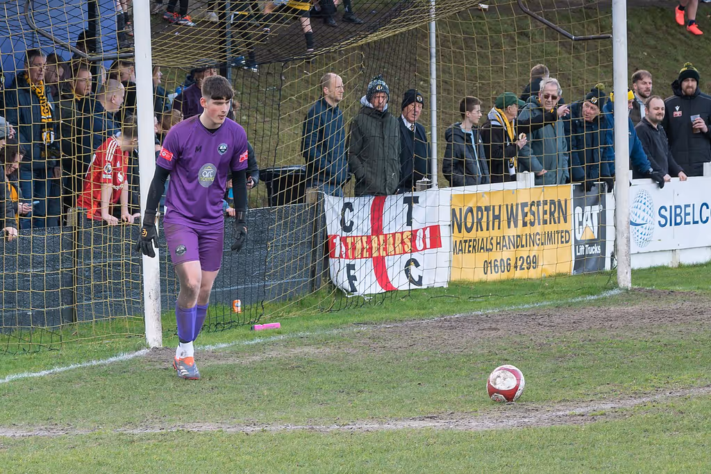 Atherton Collieries goalkeeper Solomon Honor takes a goal kick in front of the Mind Body & Sole stand at Congleton Town's Booth Street ground.